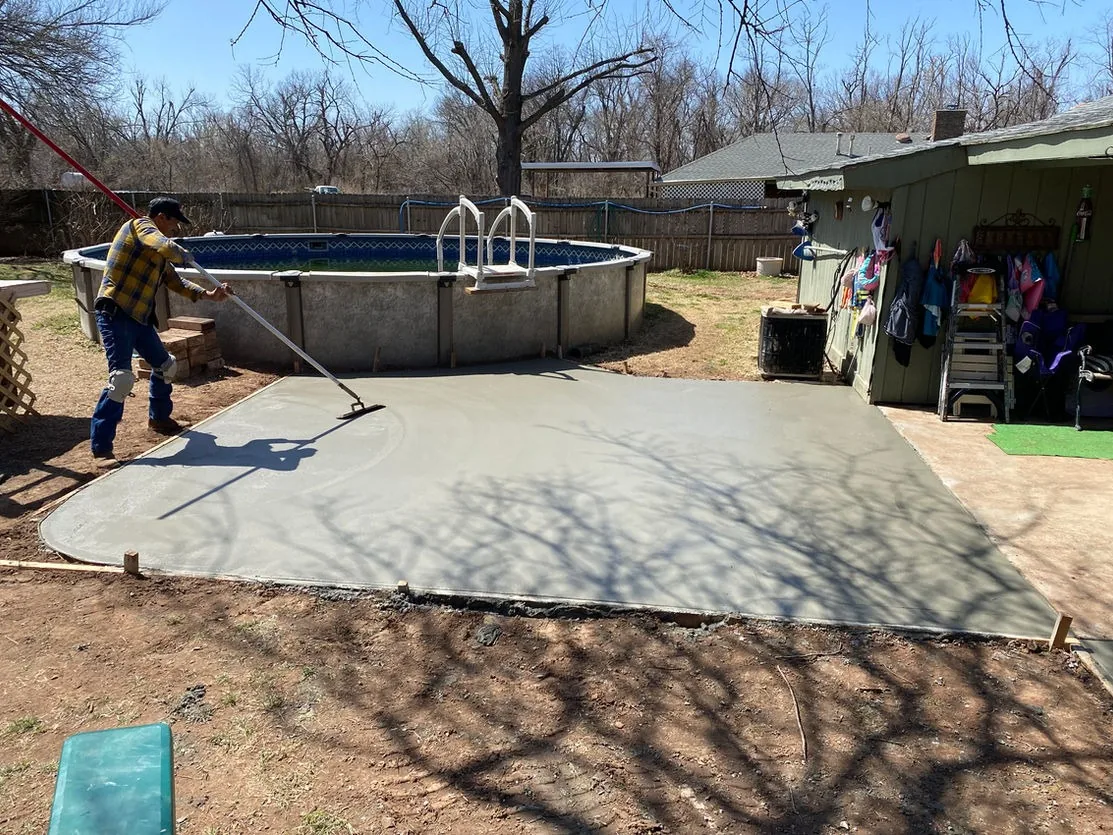 New concrete slab poured beside a backyard pool in Scottsdale, AZ