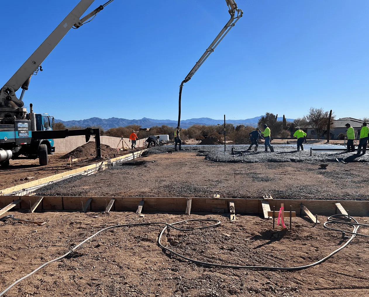 Concrete pump truck placing a residential foundation over rebar and forms in Chandler, AZ
